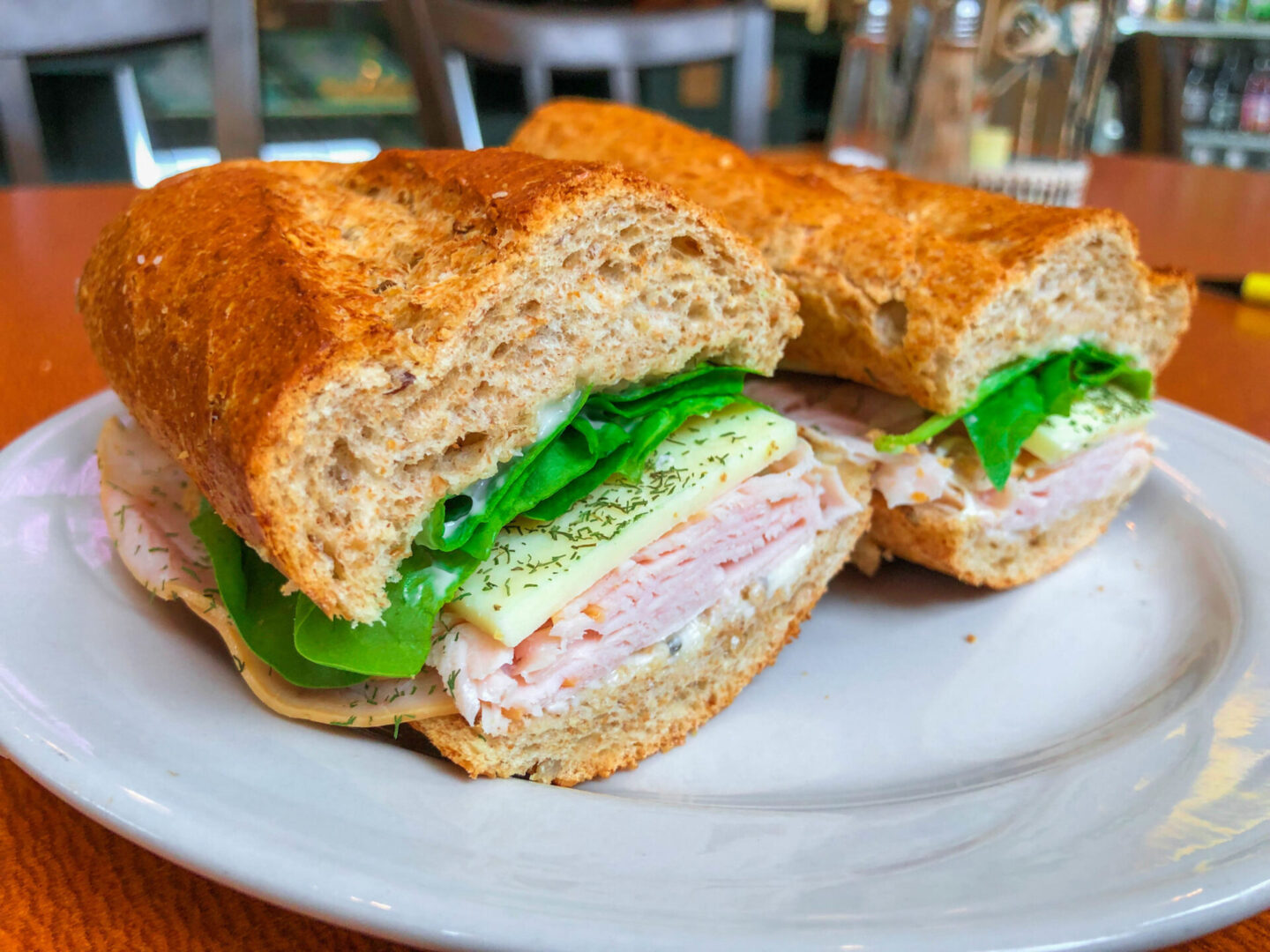 A sandwich cut in half on top of a plate.